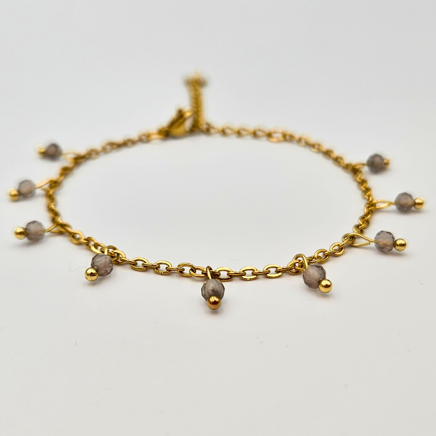 Armband van goldplated stainless steel met facetgeslepen rookkwarts