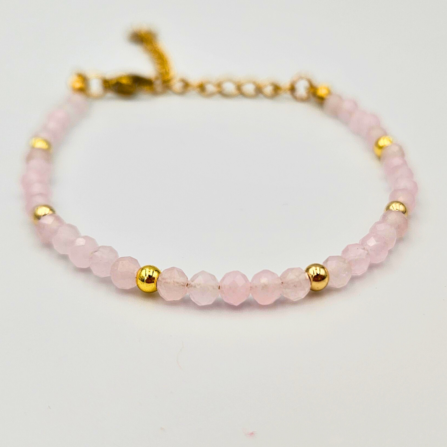 Armband van facetgeslepen rozenkwarts afgewerkt met goldplated stainless steel