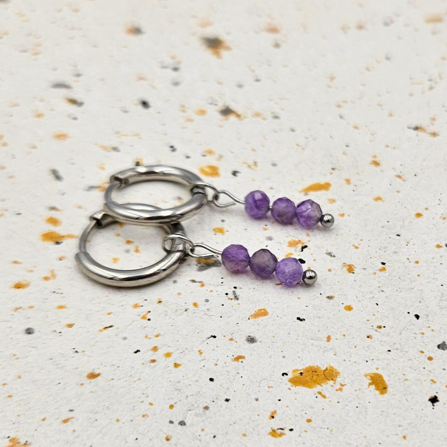 Oorbellen gemaakt van stainless steel met facetgeslepen amethist