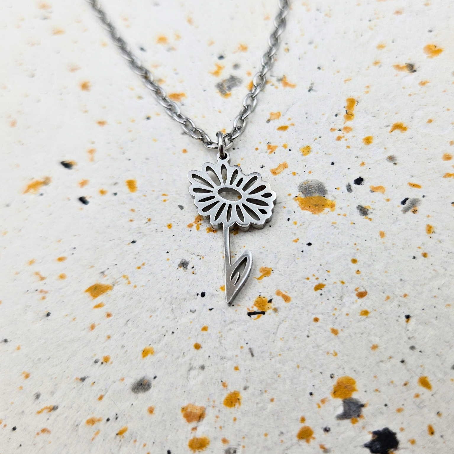 Ketting gemaakt van stainless steel met geboortebloem van april: het madeliefje